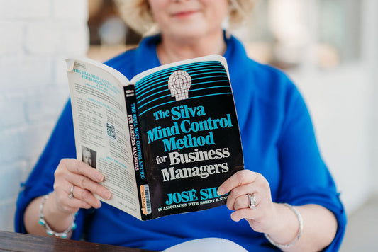 woman reading a book on the silva method
